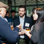 Three I School students chatting, holding drinks. (Photo by Hewitt Photography for Berkeley I School, 2019)